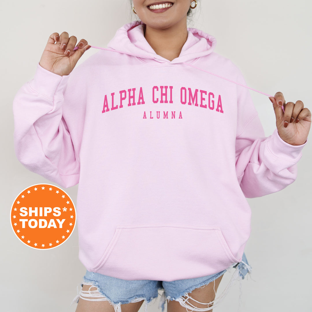 a woman wearing a pink hoodie and ripped shorts