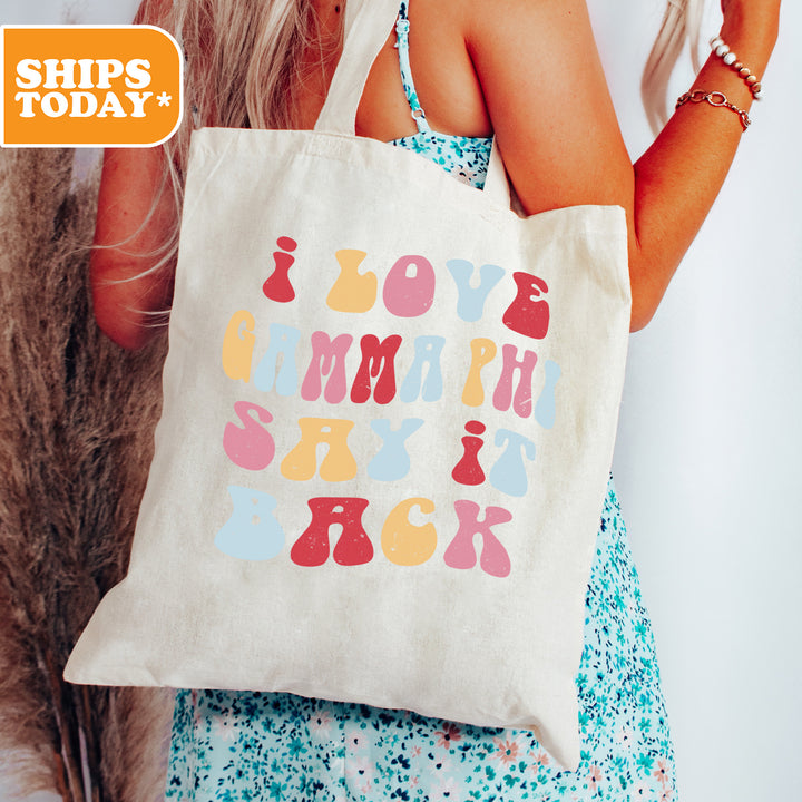 a woman holding a tote bag with the words joy and happy on it