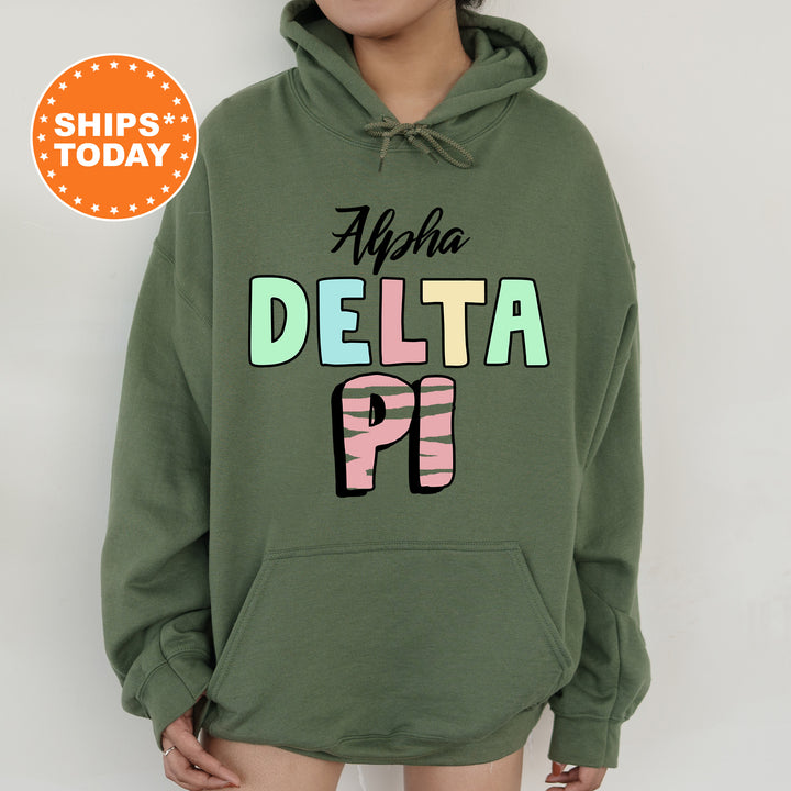 a woman wearing a green sweatshirt with the words delta pi on it