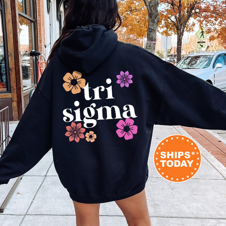 a woman in a black hoodie is walking down the street