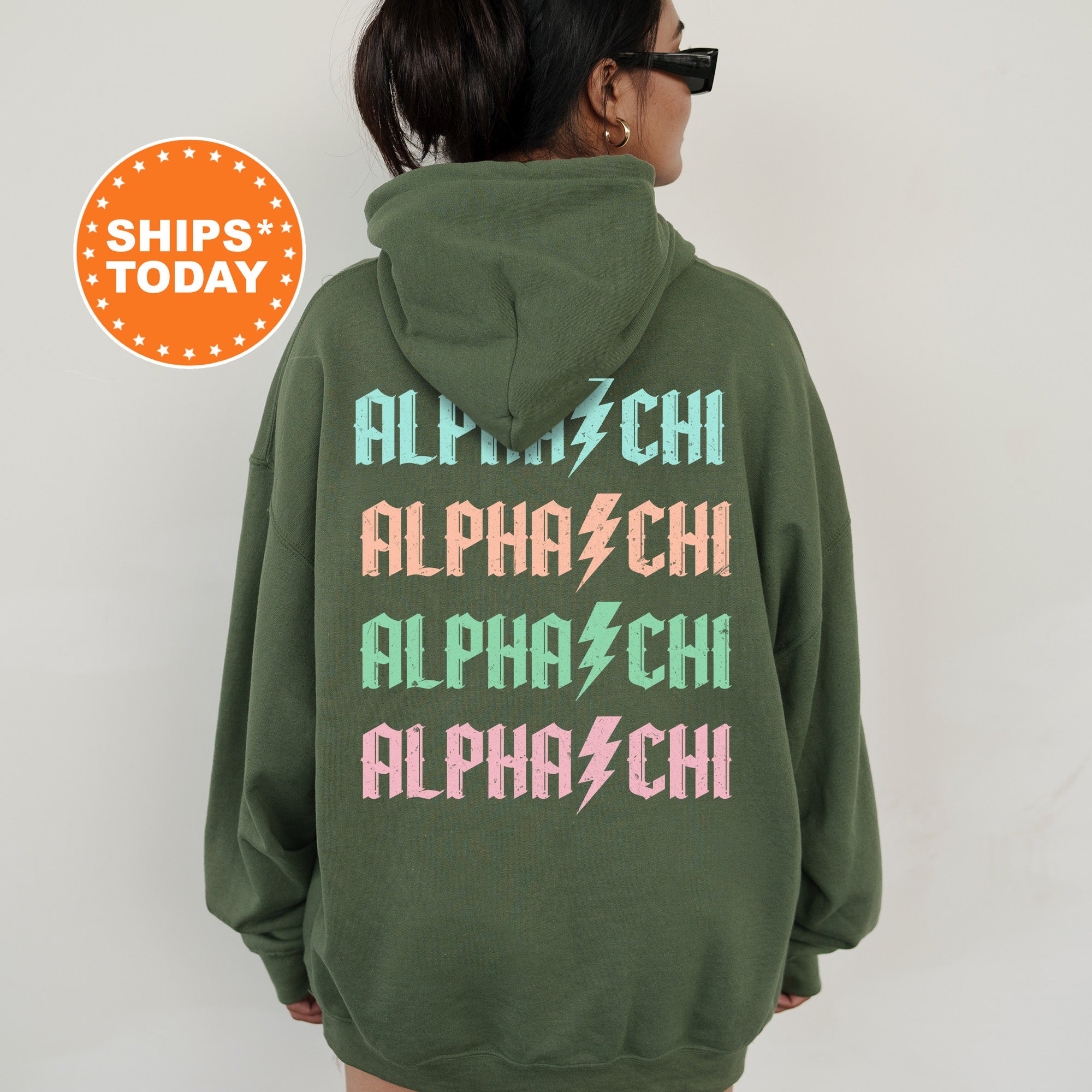 a woman wearing a green hoodie with pink and green letters on it