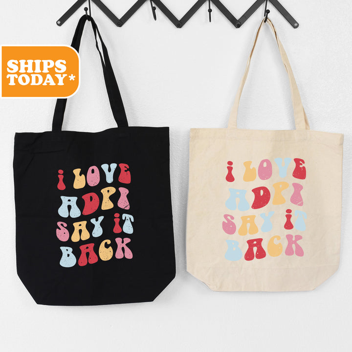 two totes hanging on a wall next to each other