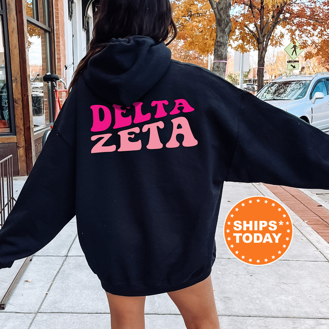 a woman in a black hoodie that says delta zeta