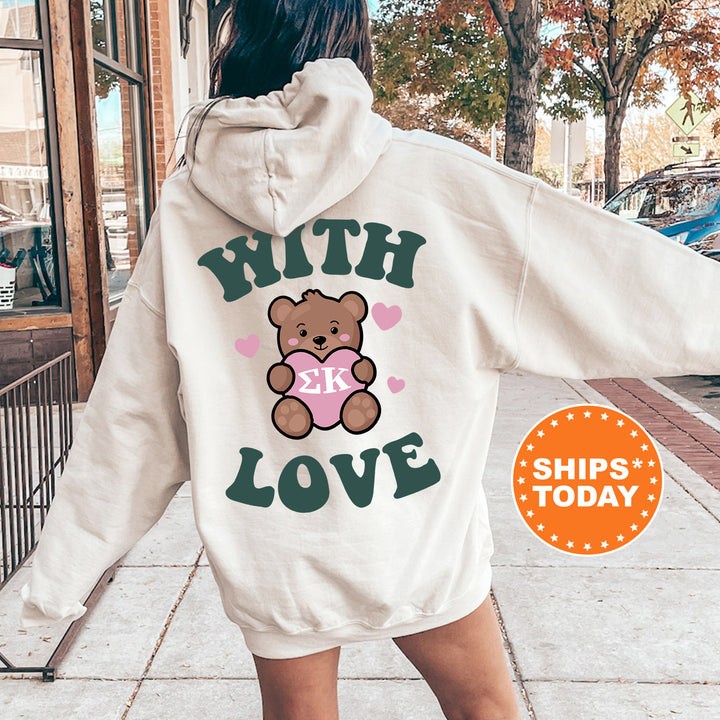 a woman wearing a white hoodie with a teddy bear on it
