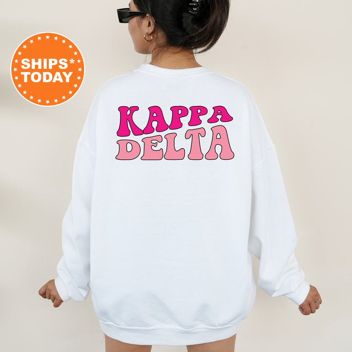 a woman wearing a white sweatshirt with the words kappa delta printed on it