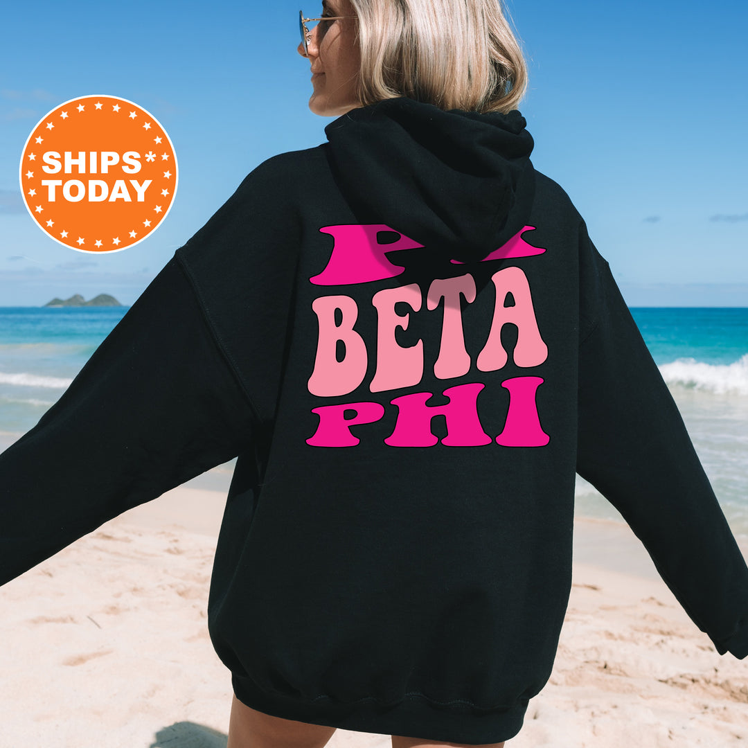 a woman wearing a black hoodie with the words beta phi printed on it