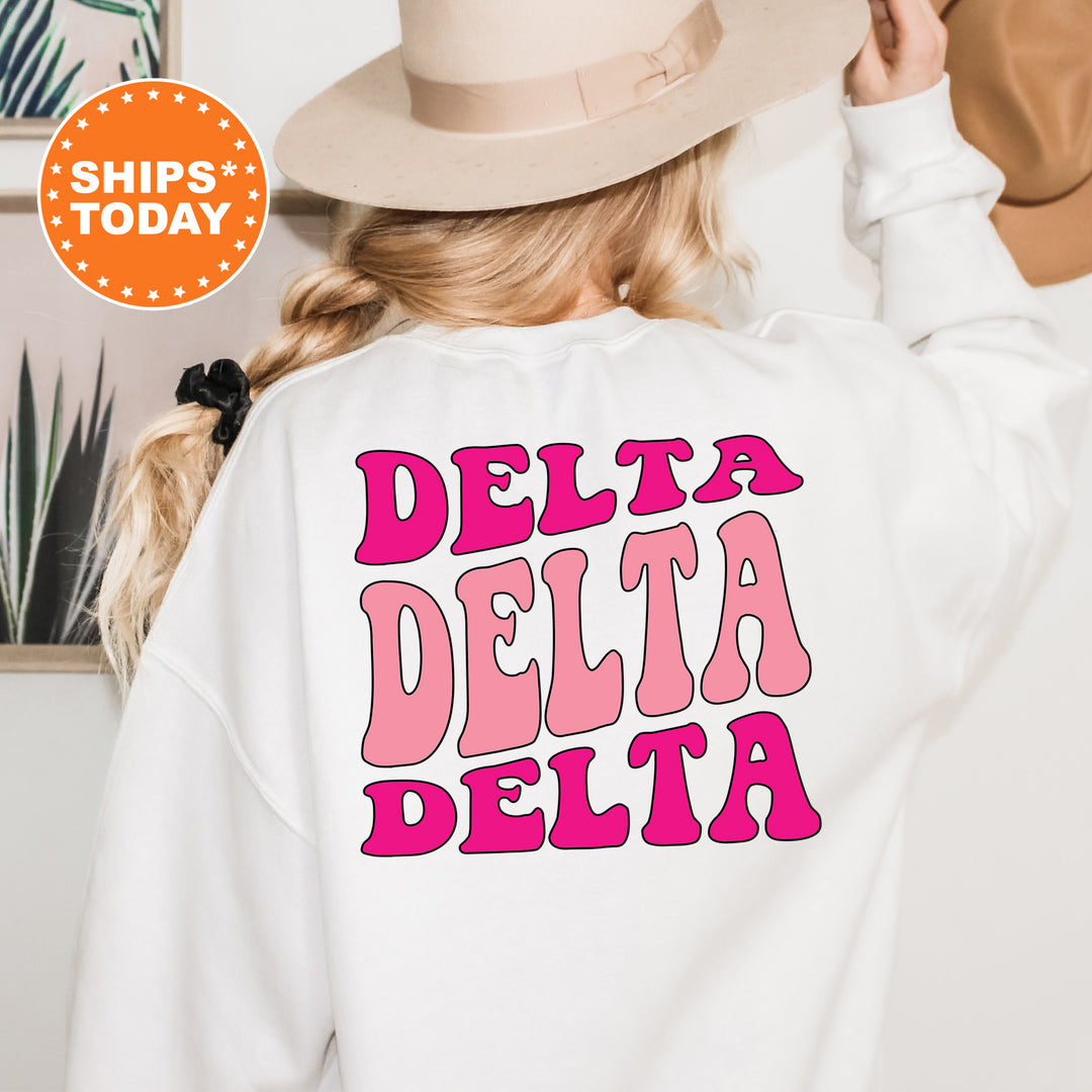 a woman wearing a white sweatshirt that says delta delta
