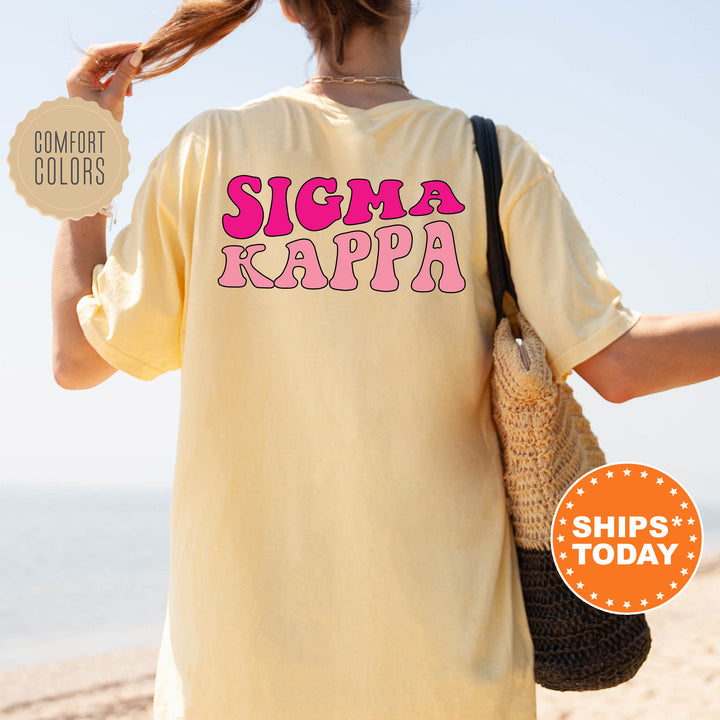 a woman holding a bag and a sign that says sigma kappa
