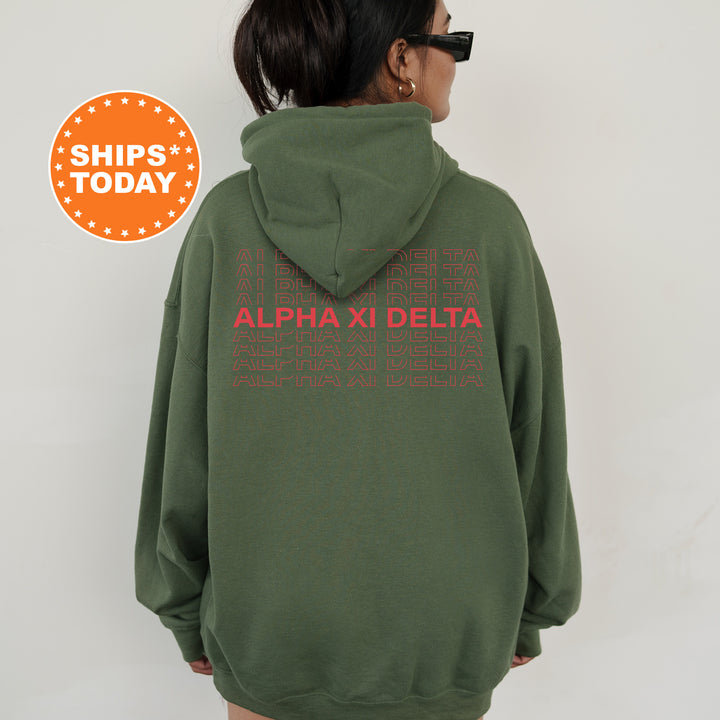 a woman wearing a green hoodie with the words alpha xi delta printed on