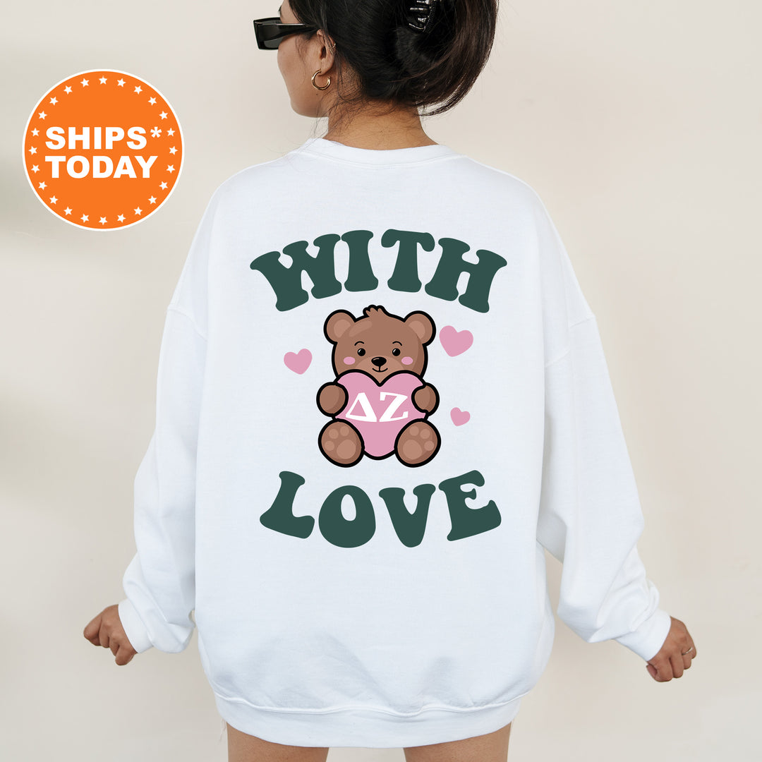 a woman wearing a white sweatshirt with a teddy bear on it