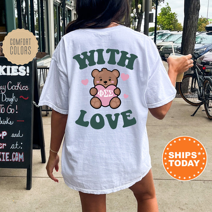 a woman wearing a white shirt with a teddy bear on it