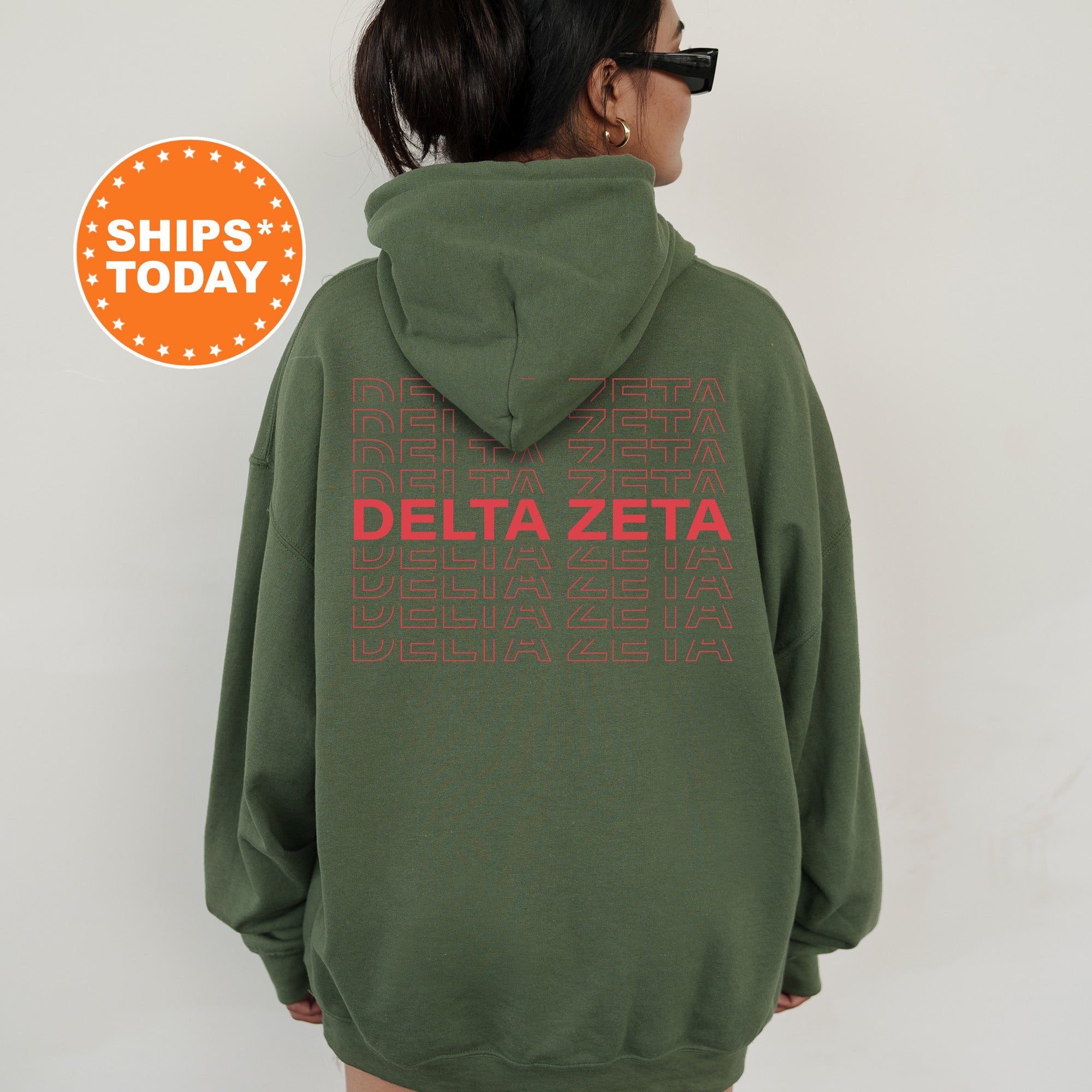 a woman wearing a green sweatshirt with the words delta zeta printed on it