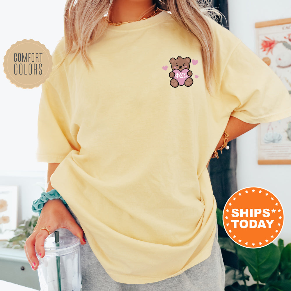 a woman wearing a yellow shirt with a teddy bear on it