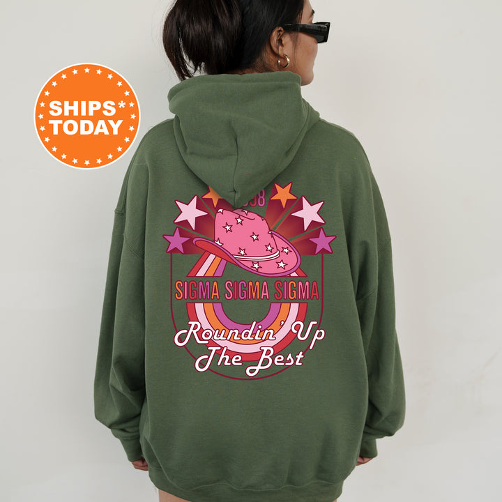 a woman wearing a green hoodie with a pink unicorn on it