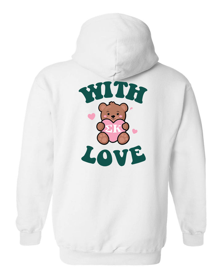 a white hoodie with a teddy bear holding a heart