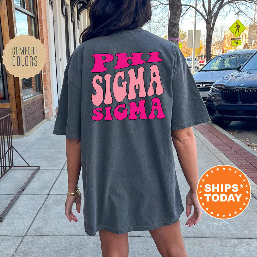 a woman walking down a sidewalk wearing a shirt that says phi sigma stigma