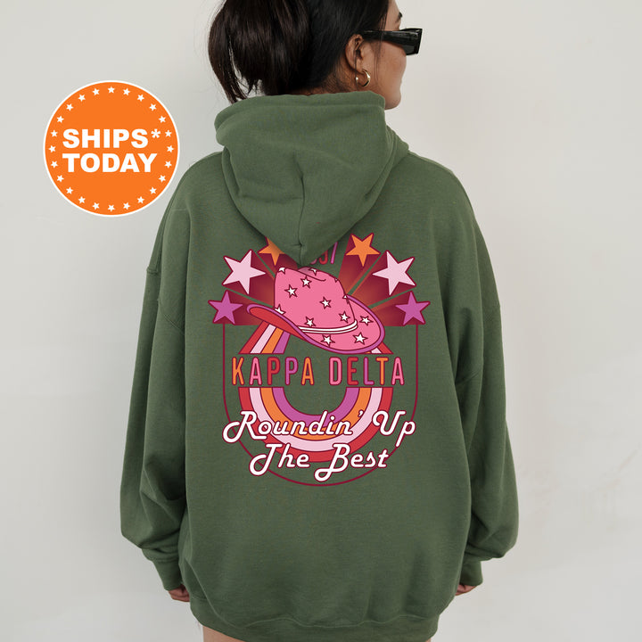 a woman wearing a green hoodie with the words kapa delta on it