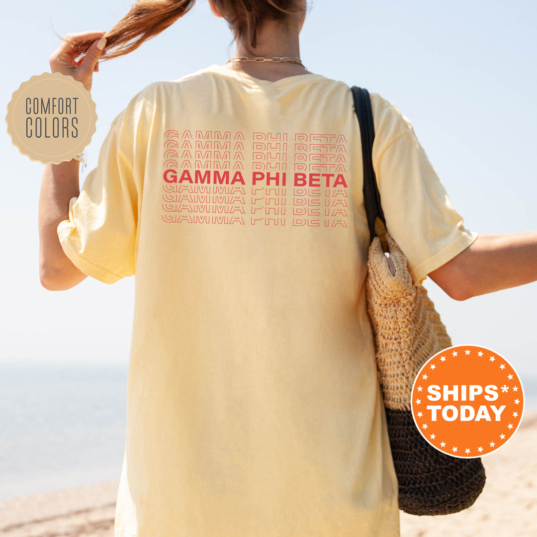 a woman holding up a sign that says gama phi beta