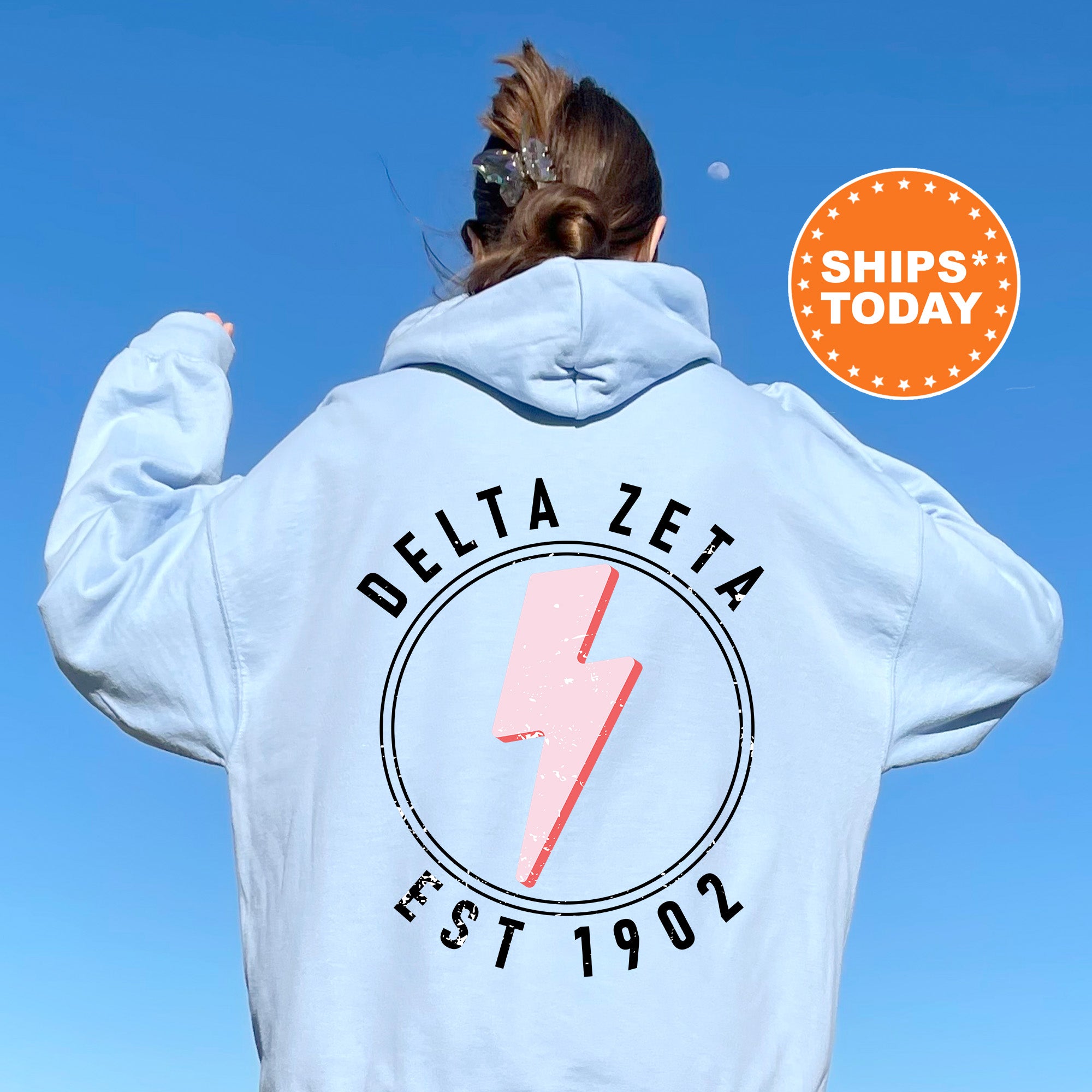 a woman in a white hoodie with a lightning bolt on it