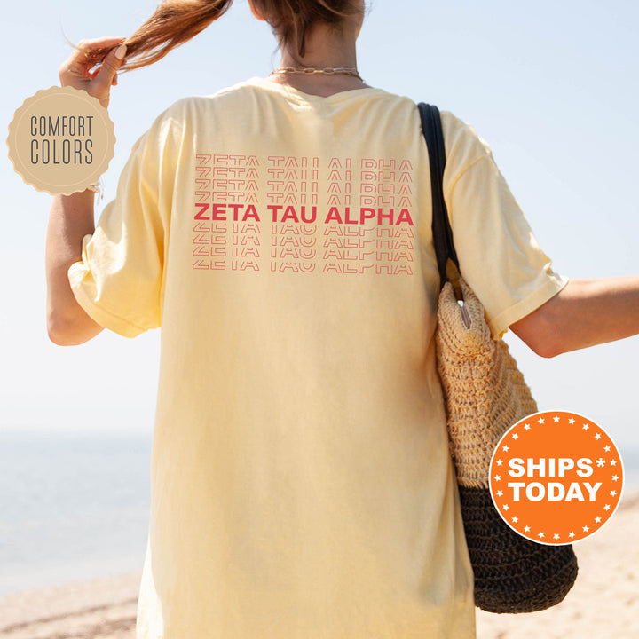 a woman holding a sign that says zetta tau aha ships today