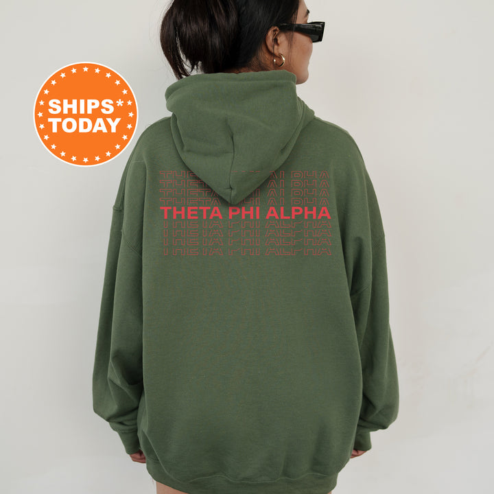 a woman wearing a green hoodie with the words, theaphi alpha