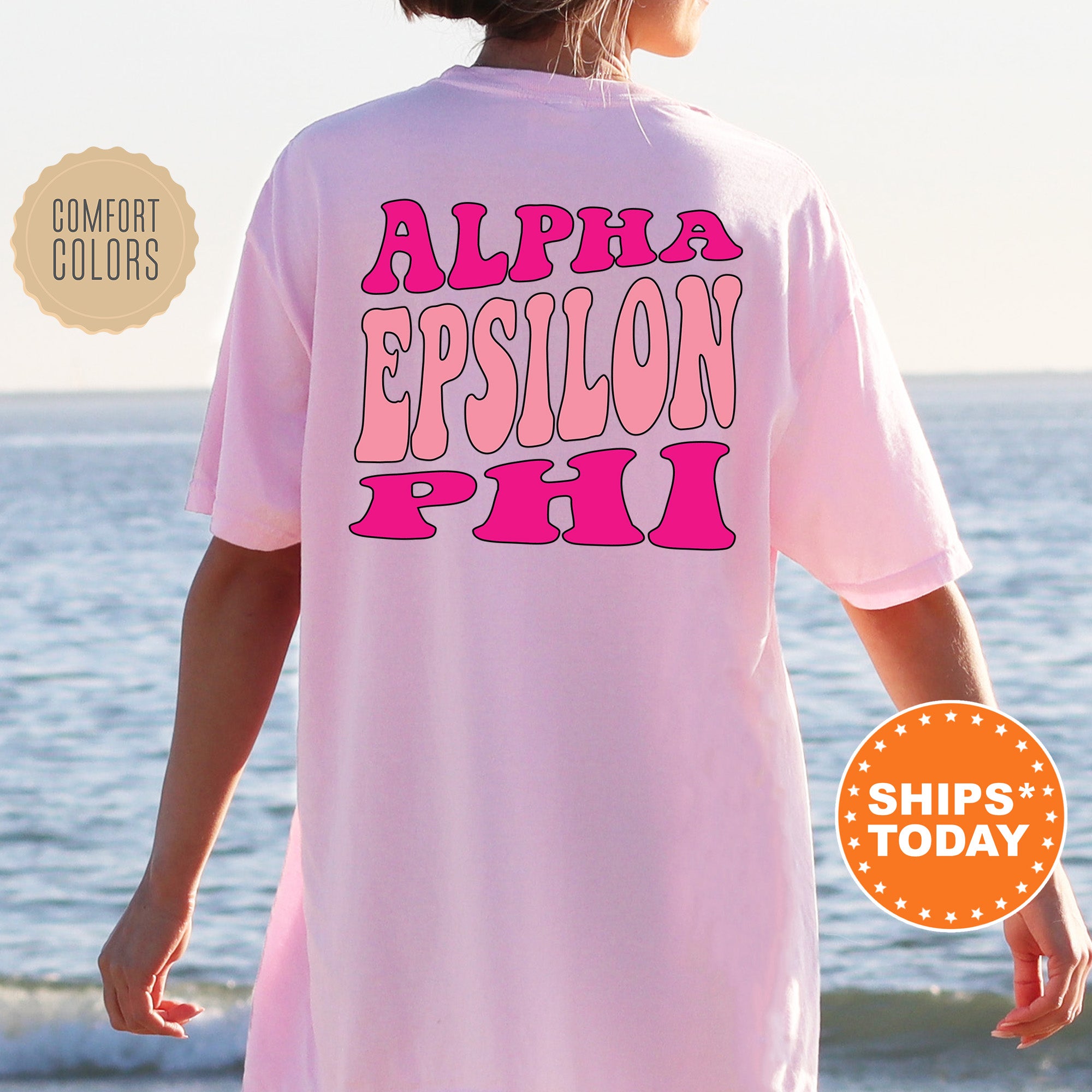 a woman wearing a pink shirt that says, alphi epsilon pho