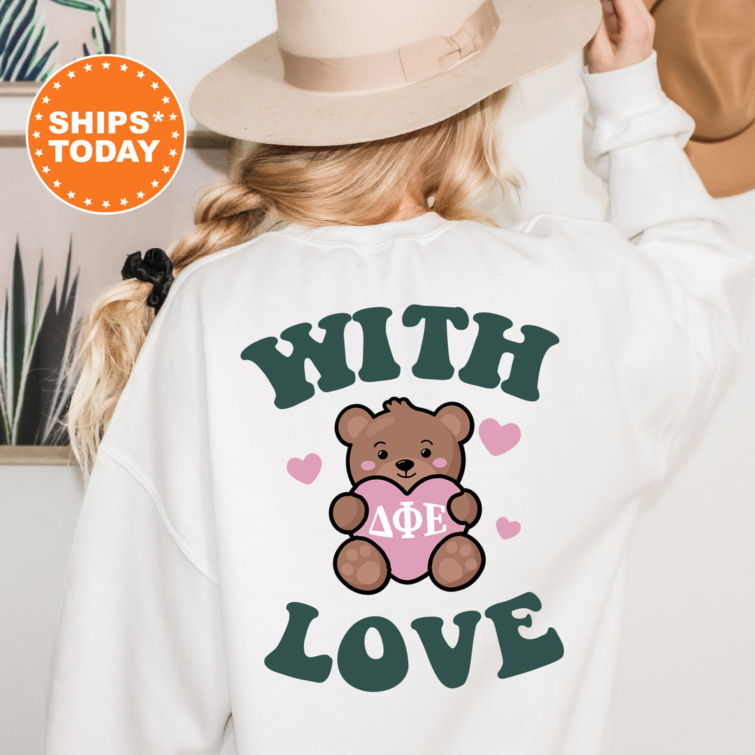a woman wearing a white sweatshirt with a brown teddy bear on it