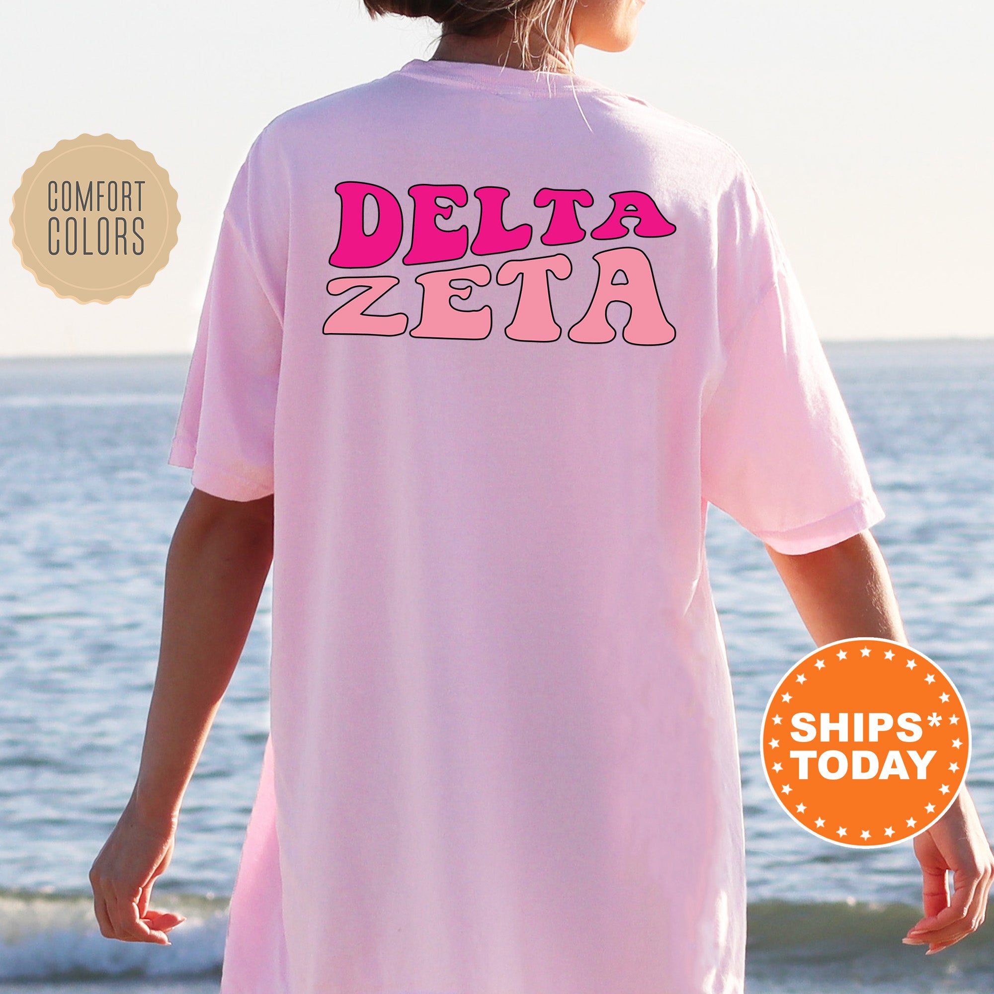 a woman wearing a pink shirt that says delta zeta