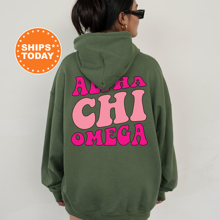 a woman wearing a green hoodie with pink letters on it