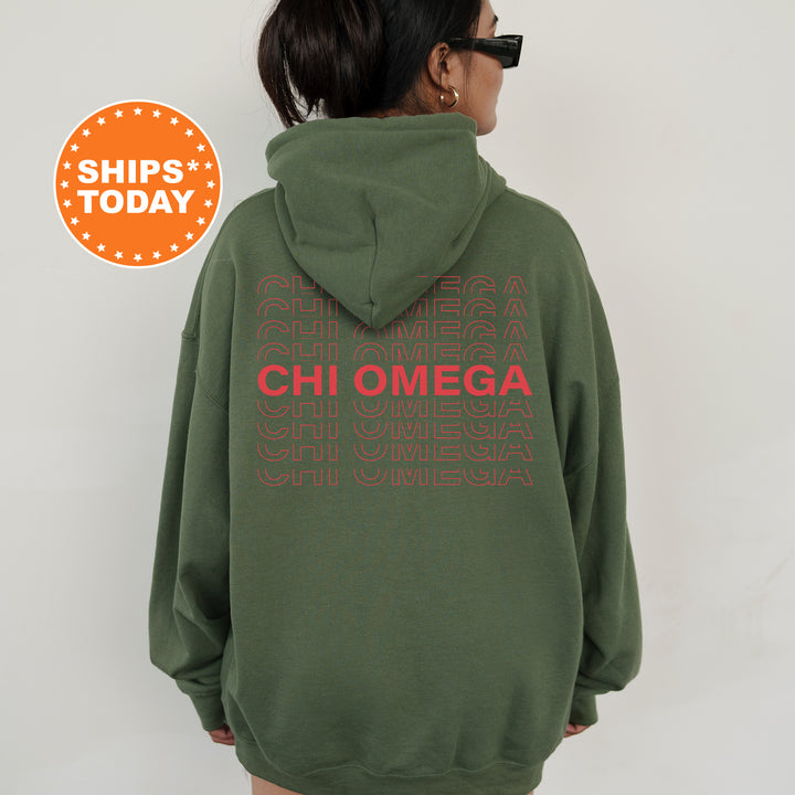 a woman wearing a green hoodie with the words chi omega printed on it