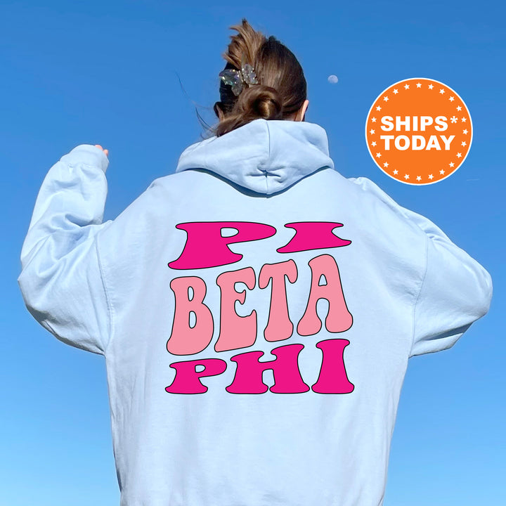 a woman wearing a white hoodie that says beta pai