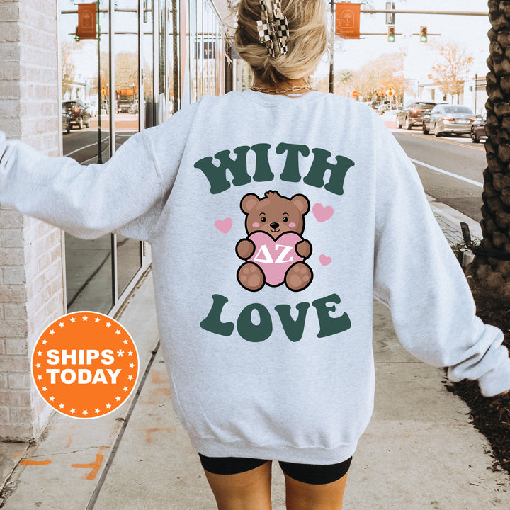 a woman walking down a sidewalk with a teddy bear on her back