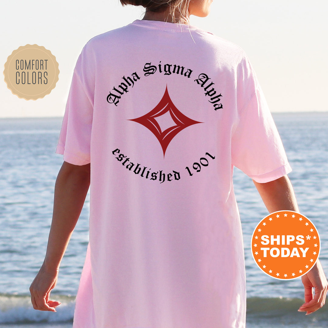 a woman standing on a beach wearing a pink shirt