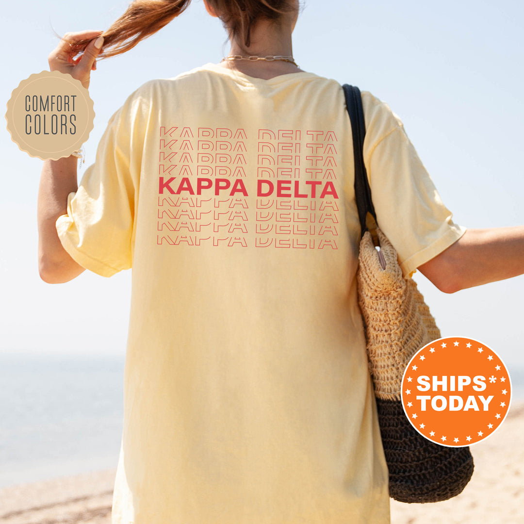 a woman holding a bag and a sign that says kapa delta
