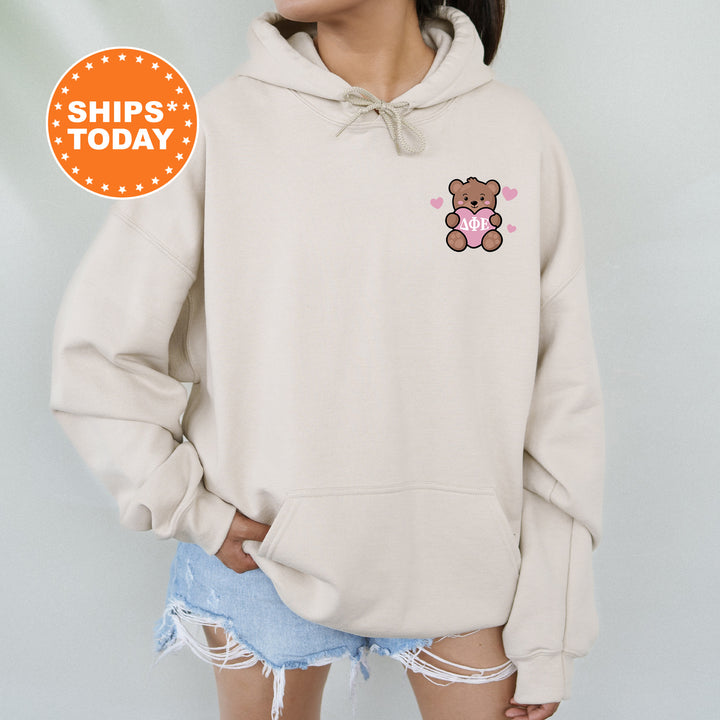 a woman wearing a hoodie with a teddy bear on it