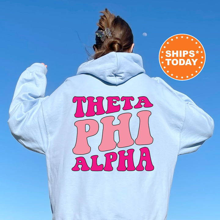 a woman wearing a white hoodie with pink letters on it