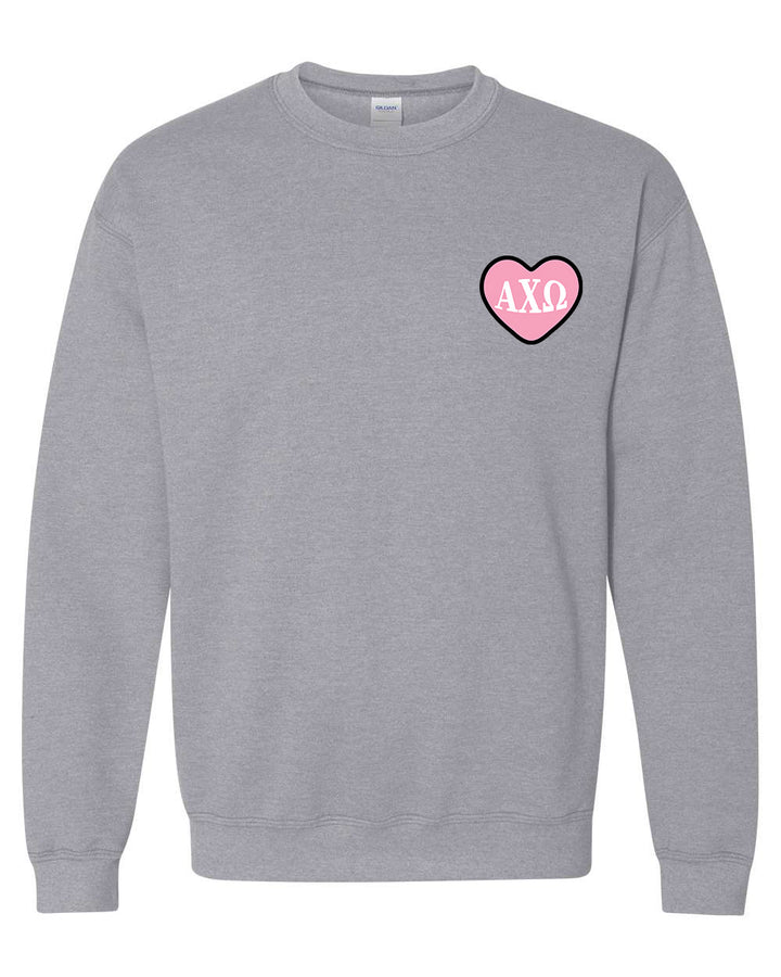 a grey sweatshirt with a pink heart on the chest