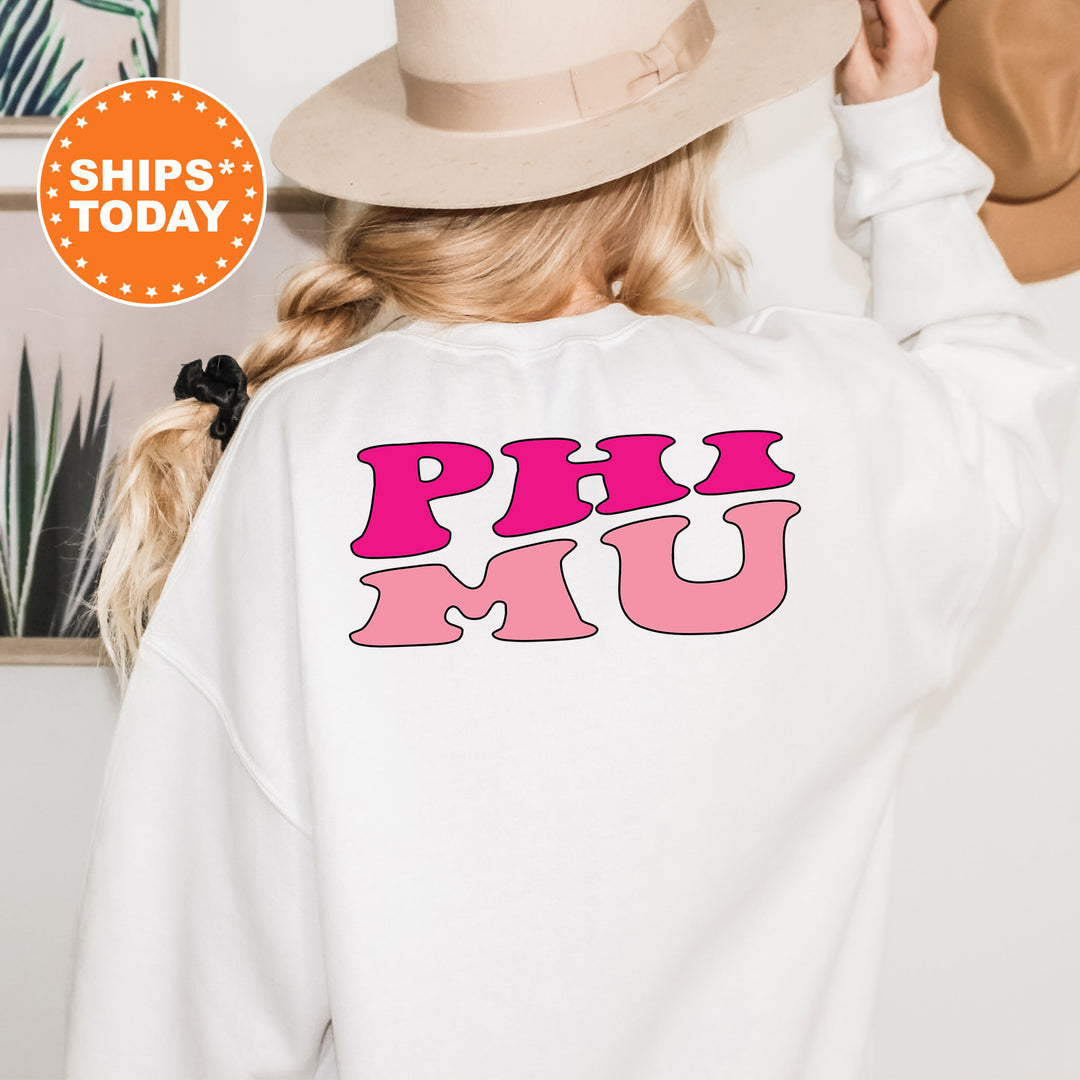 a woman wearing a white sweatshirt with pink letters on it