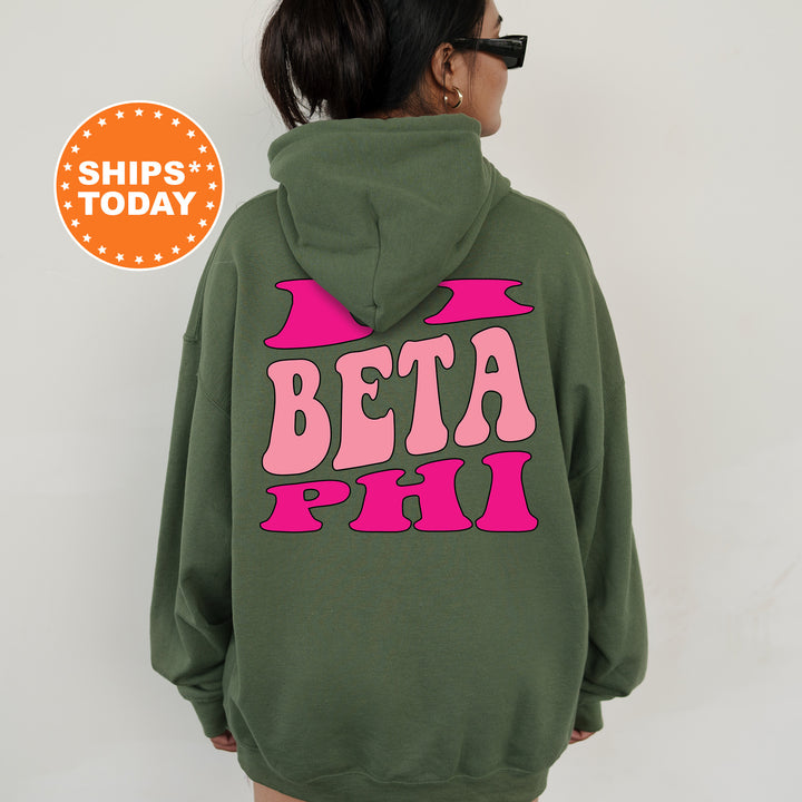 a woman wearing a green hoodie that says beta phi