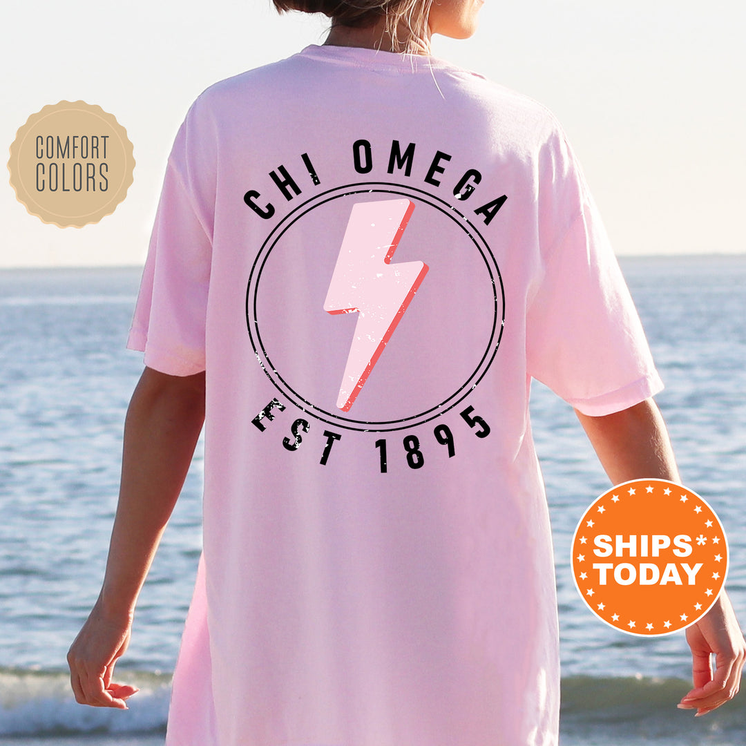 a woman wearing a pink shirt with a lightning bolt on it