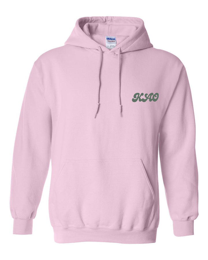 a pink hoodie with a green logo on it