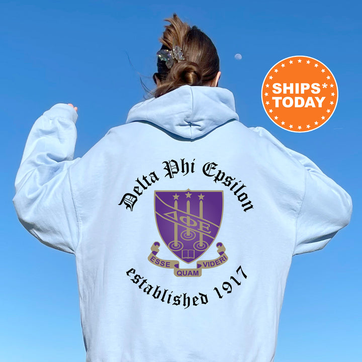 a woman wearing a white hoodie with a purple crest on it