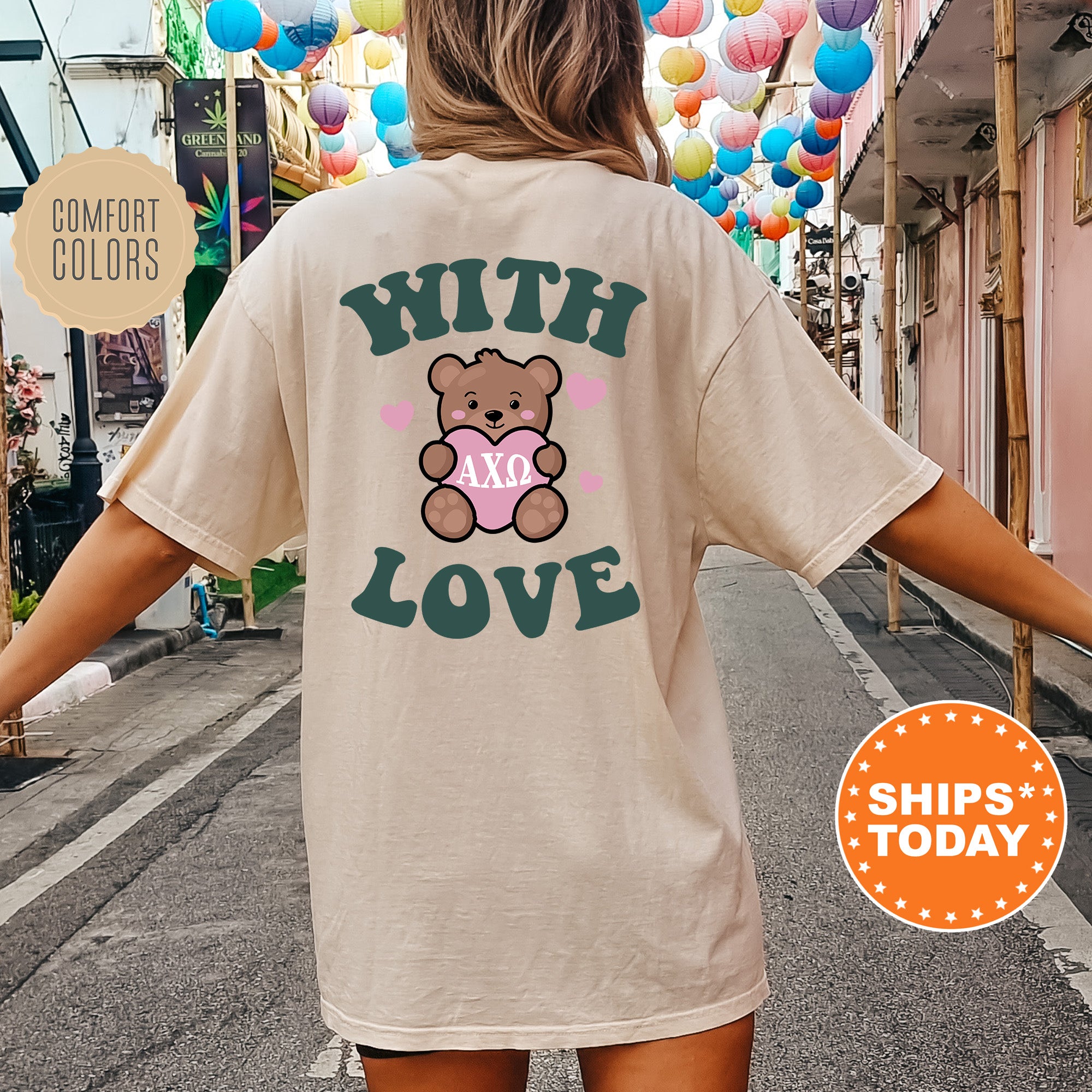 a woman walking down a street with a teddy bear on her shirt