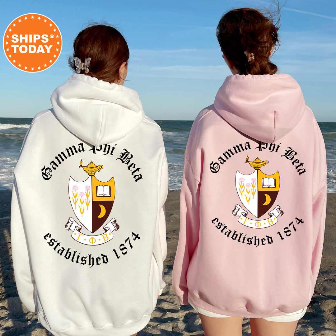 two girls wearing matching sweatshirts on the beach