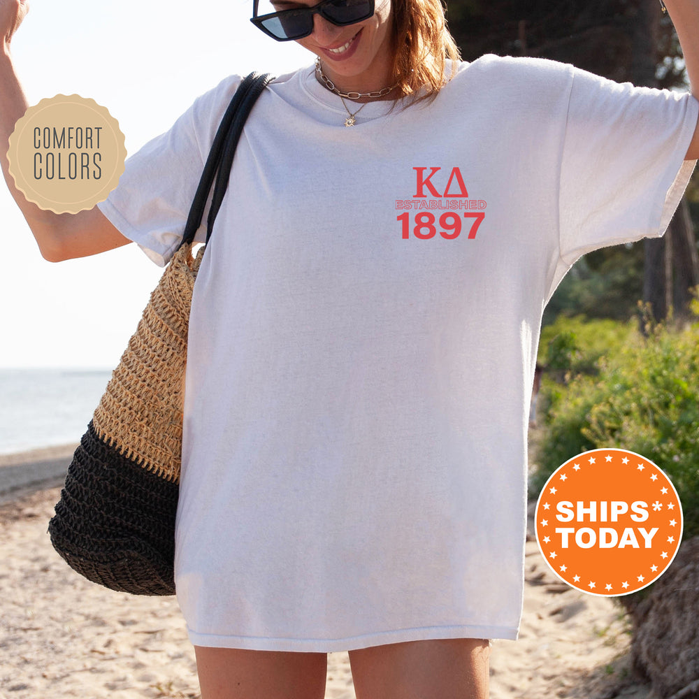 a woman wearing a t - shirt with a k a logo on it