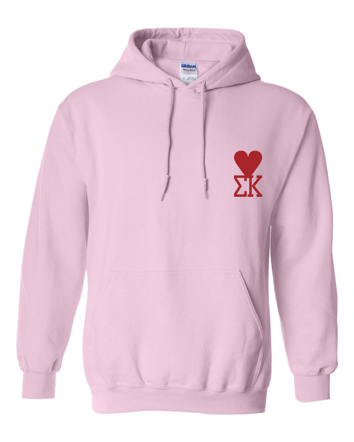 a pink hoodie with a red heart on it