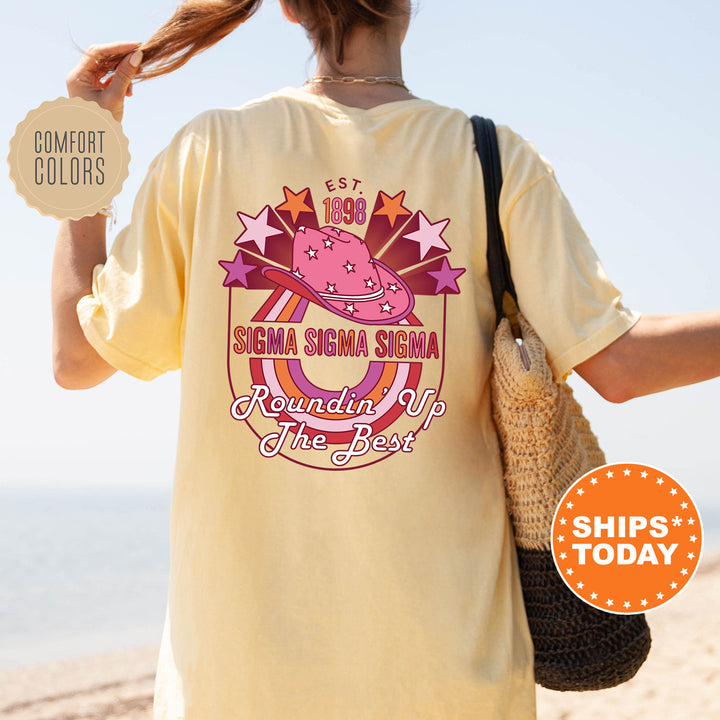 a woman walking on a beach holding a frisbee