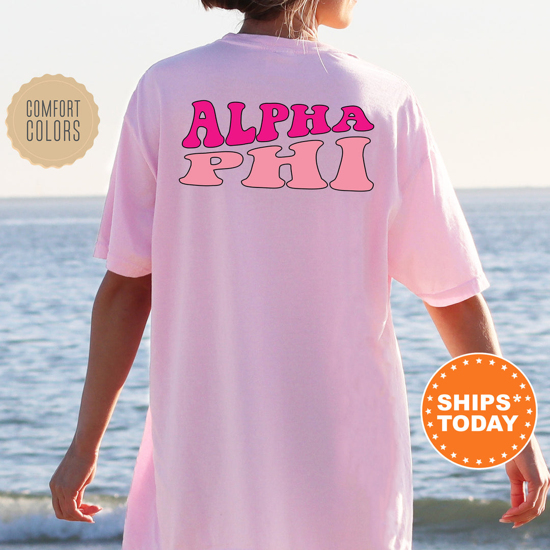 a woman wearing a pink shirt that says, alpha piu