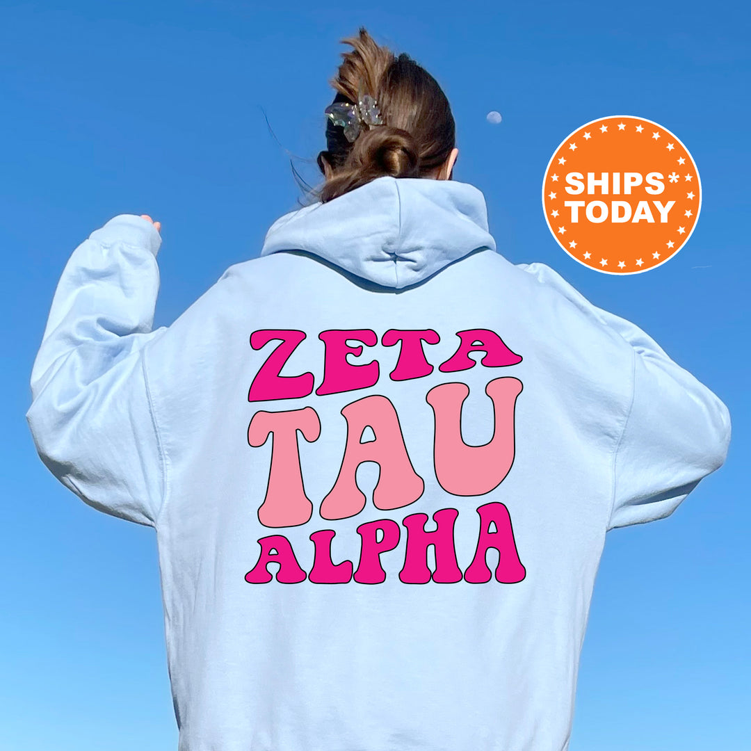 a woman wearing a white hoodie with pink letters on it