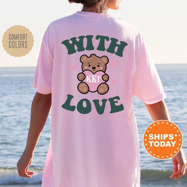 a woman wearing a pink tshirt with a teddy bear on it